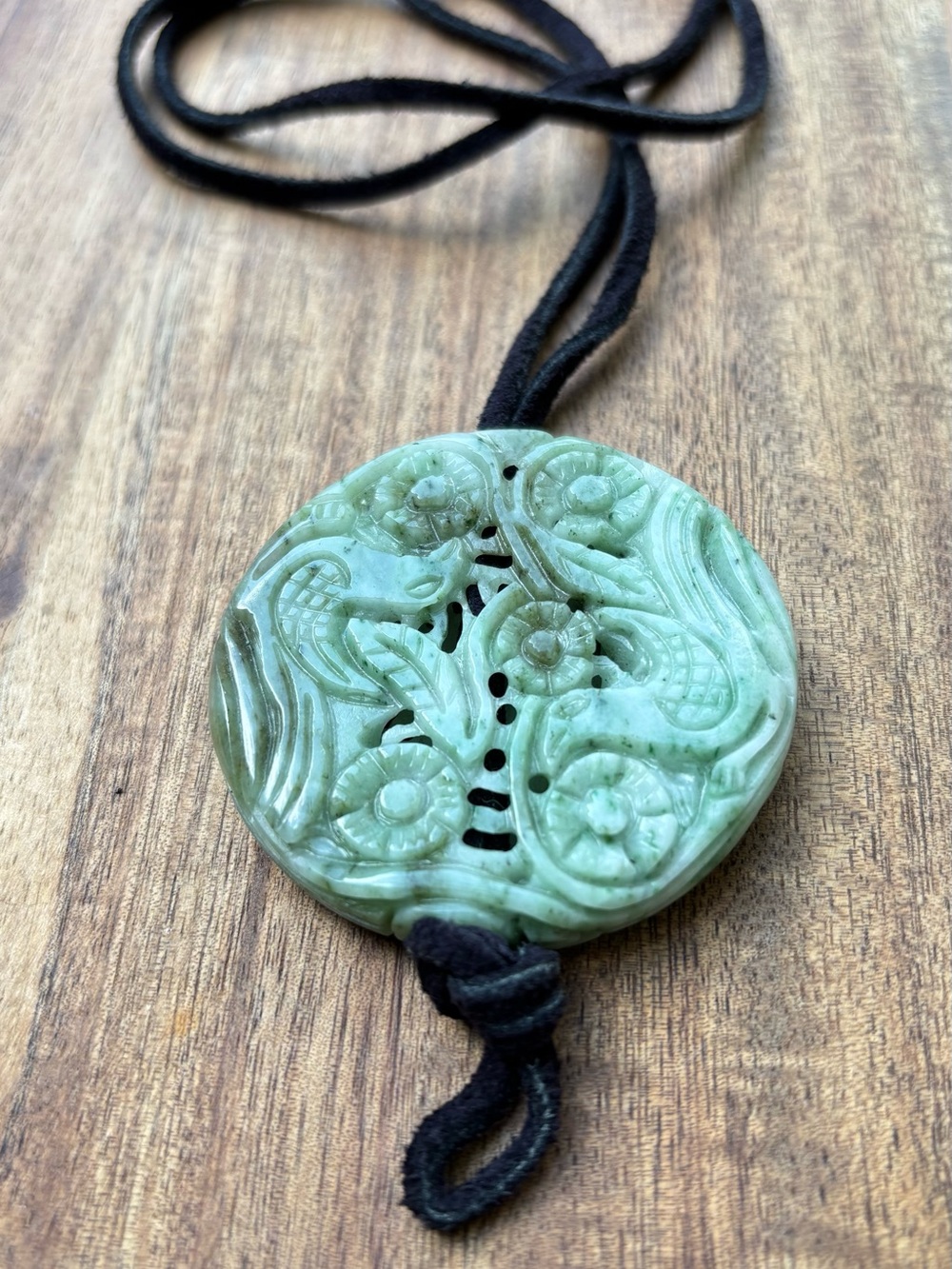 Jadeite carved pendant on a leather cord